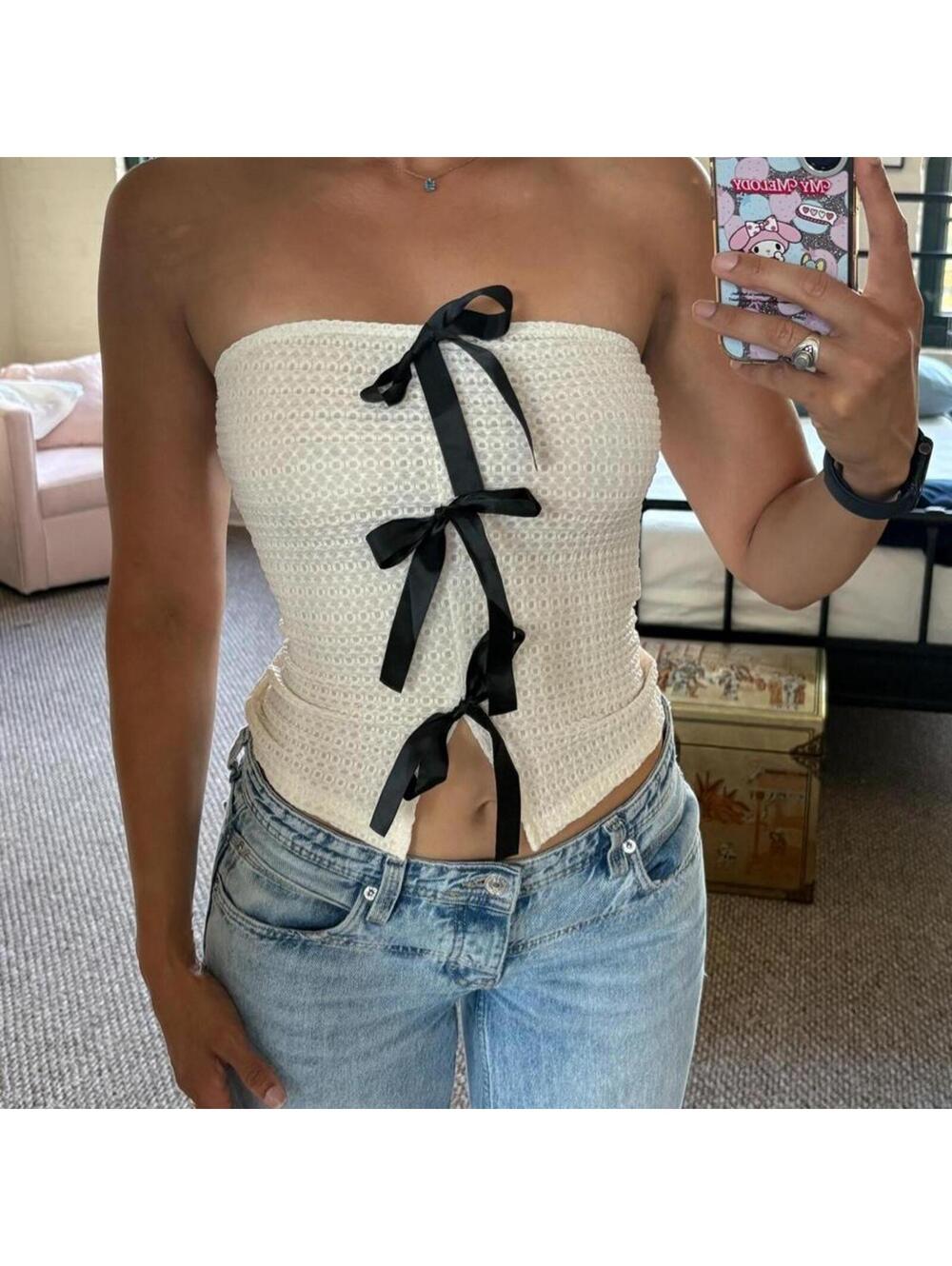 Cream waffle-knit strapless corset top with three black satin ribbon bow